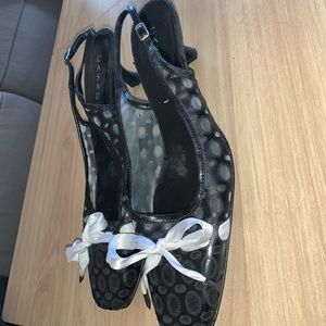 Black Casadei shoes with white bow. Kitten heel. Barely worn. Minimal damage.